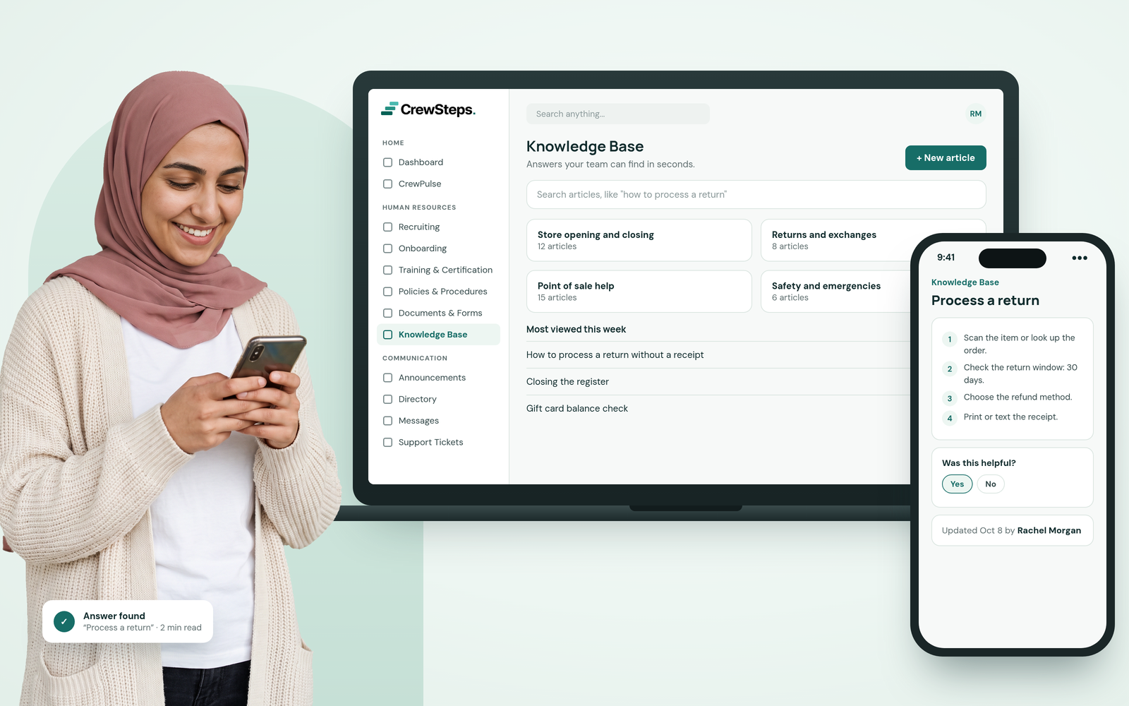 A smiling young retail shift lead in a rose hijab reading her phone beside a CrewSteps laptop showing Knowledge Base sections and a phone with step-by-step return instructions.